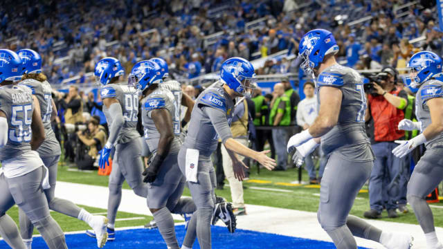 Detroit Lions quarterback Jared Goff greets his teammates taking the field.
